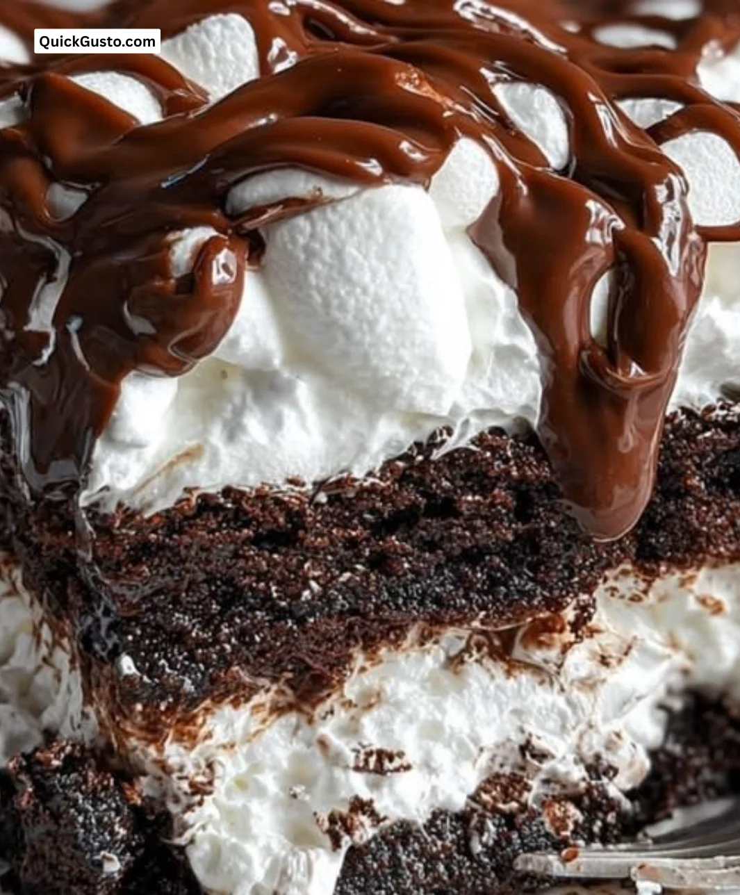 Delicious Marshmallow Chocolate Poke Cake with chocolate drizzle and marshmallow topping