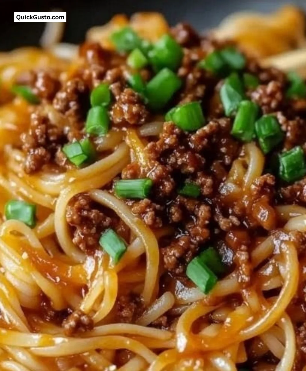 Delicious Mongolian Beef Noodles garnished with green onions and sesame seeds