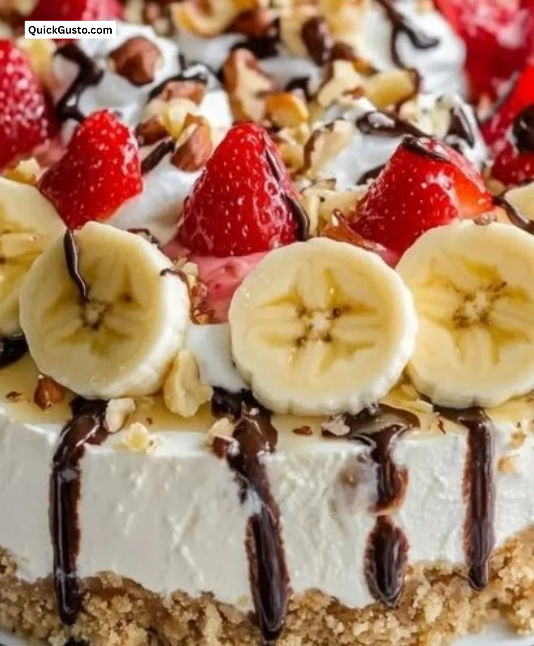 No bake banana split cheesecake topped with cherries and whipped cream
