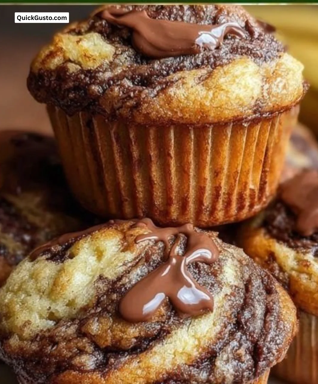 Delicious Nutella banana swirl muffins on a plate, ready to enjoy.