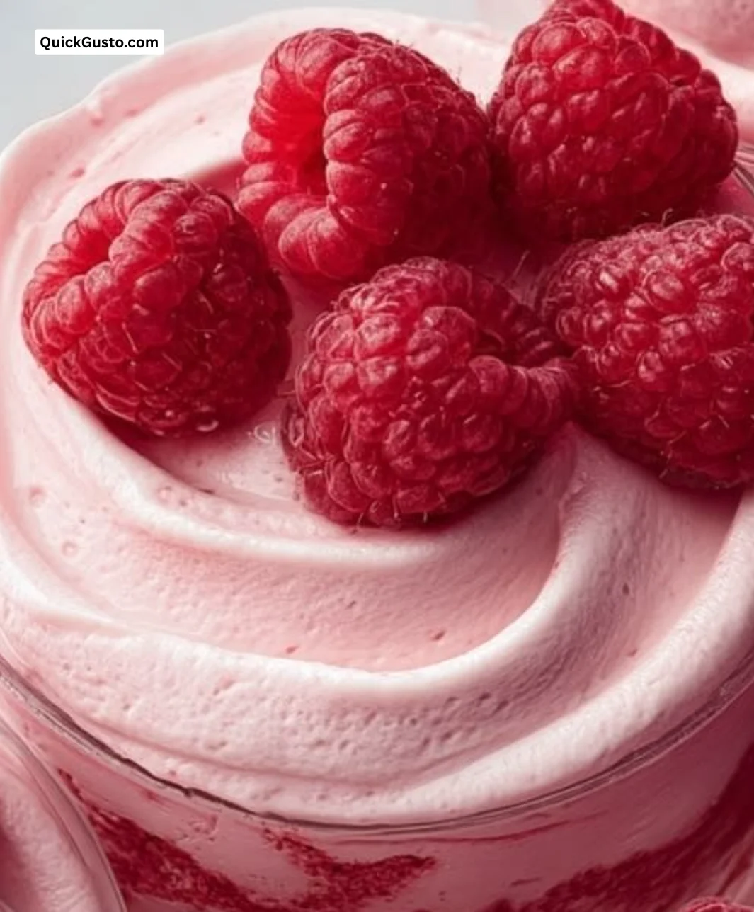 Delicious Raspberry Mousse dessert topped with fresh raspberries