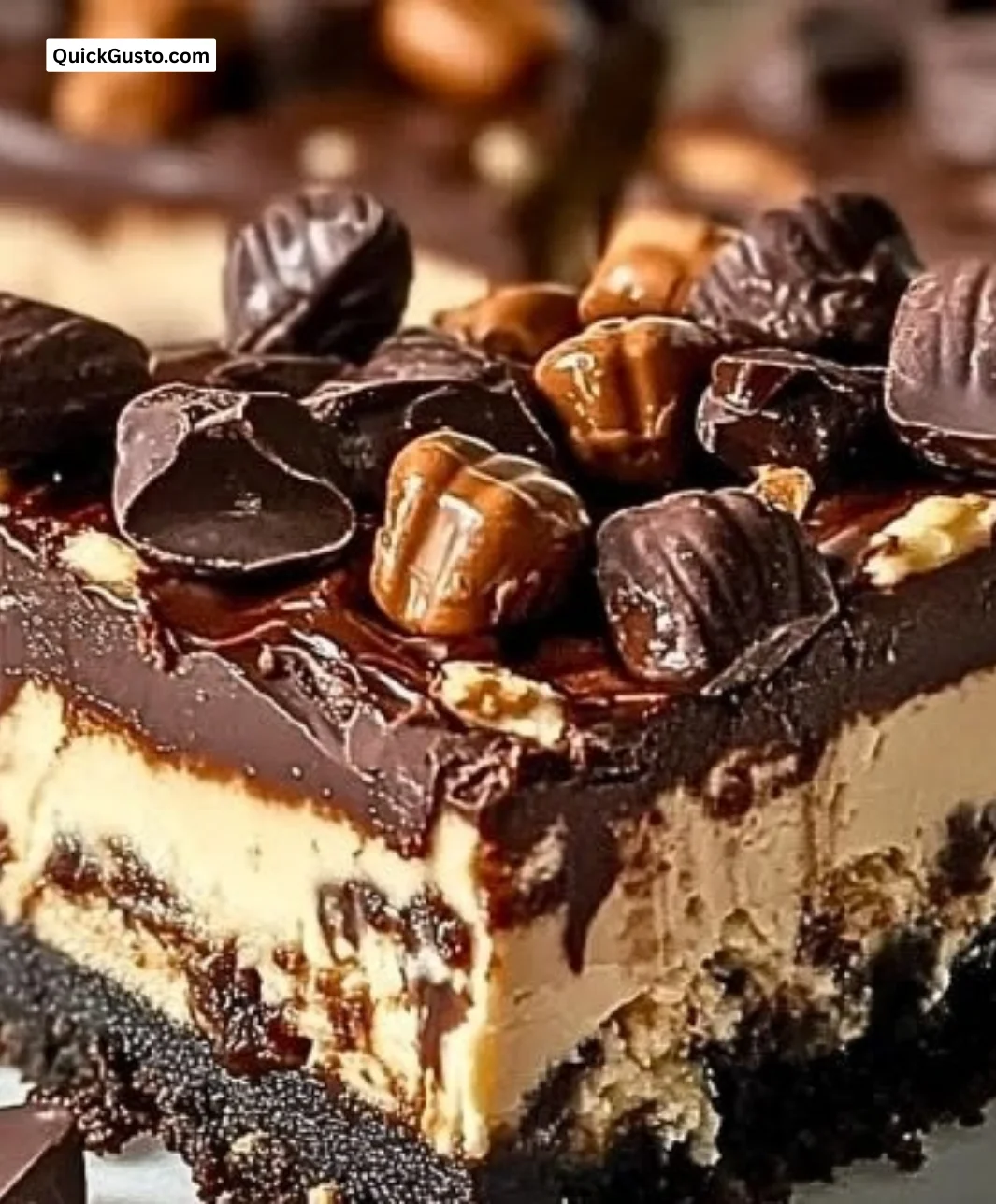Delicious Reese's cheesecake bars topped with chocolate and peanut butter.