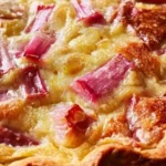 Delicious rhubarb custard pie slice on a plate with fork
