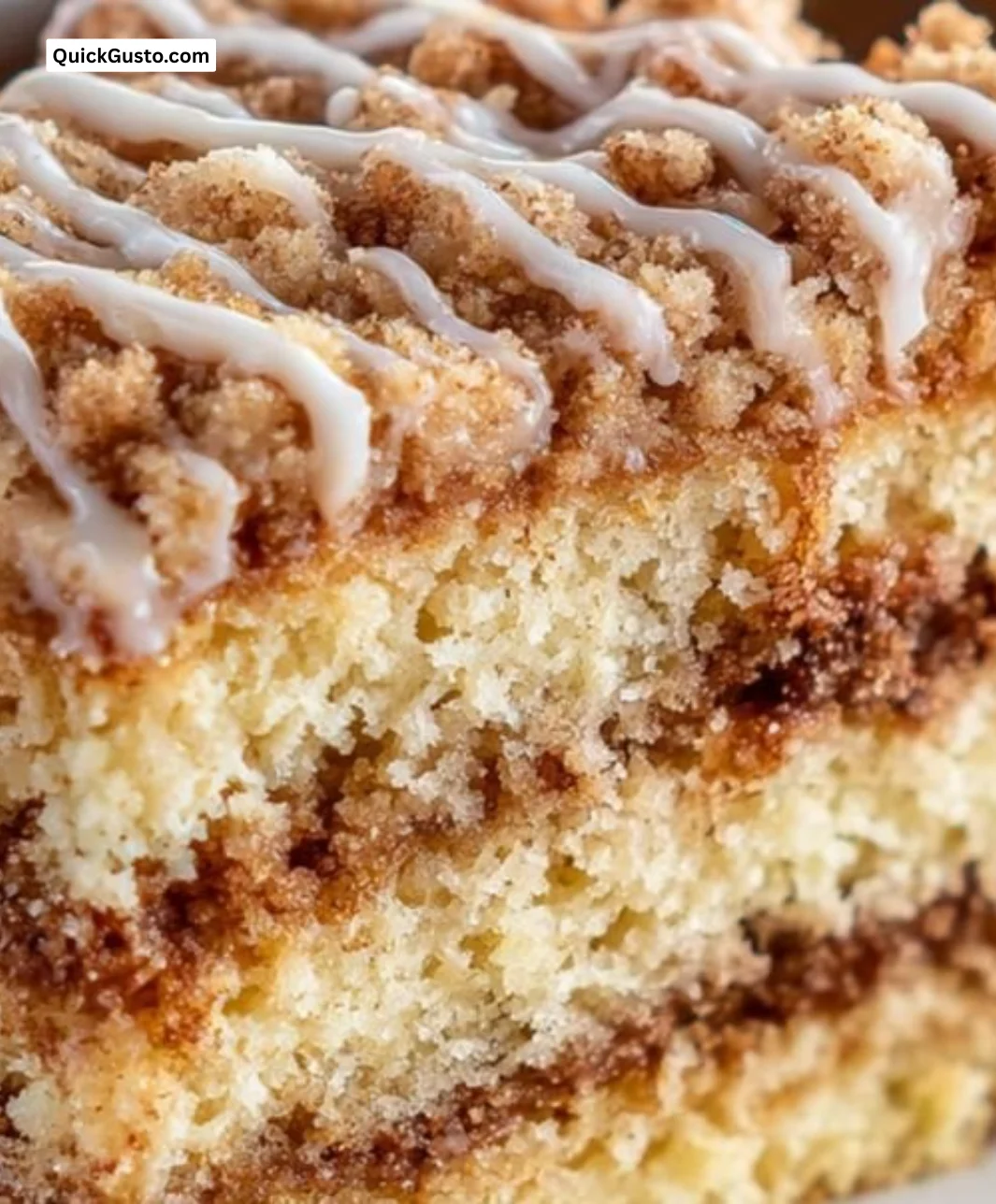 Delicious sour cream coffee cake sliced and served on a plate
