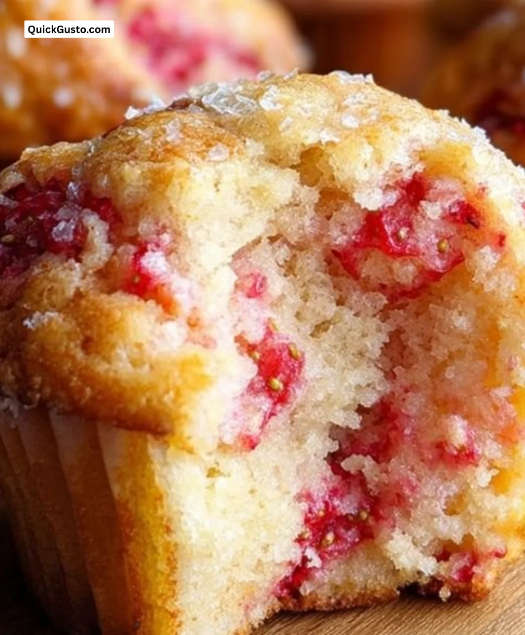 Freshly baked strawberry muffins on a wooden table