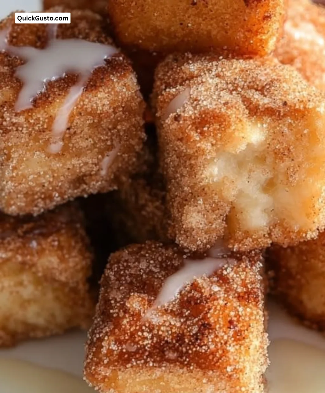 Plate of tasty angel cake churro bites dusted with cinnamon sugar.