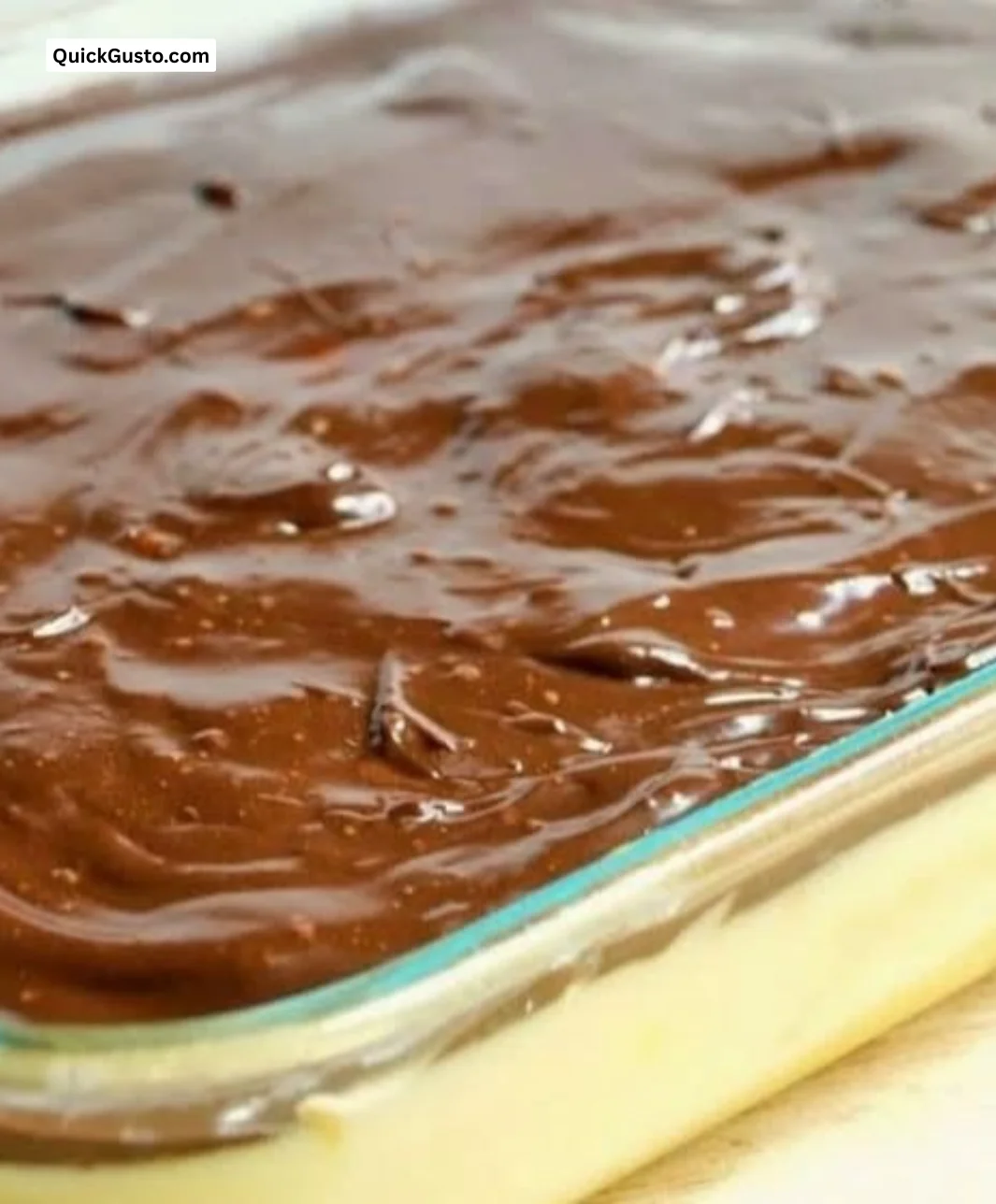 Delicious Boston Cream Pie Poke Cake made from scratch, topped with chocolate frosting.