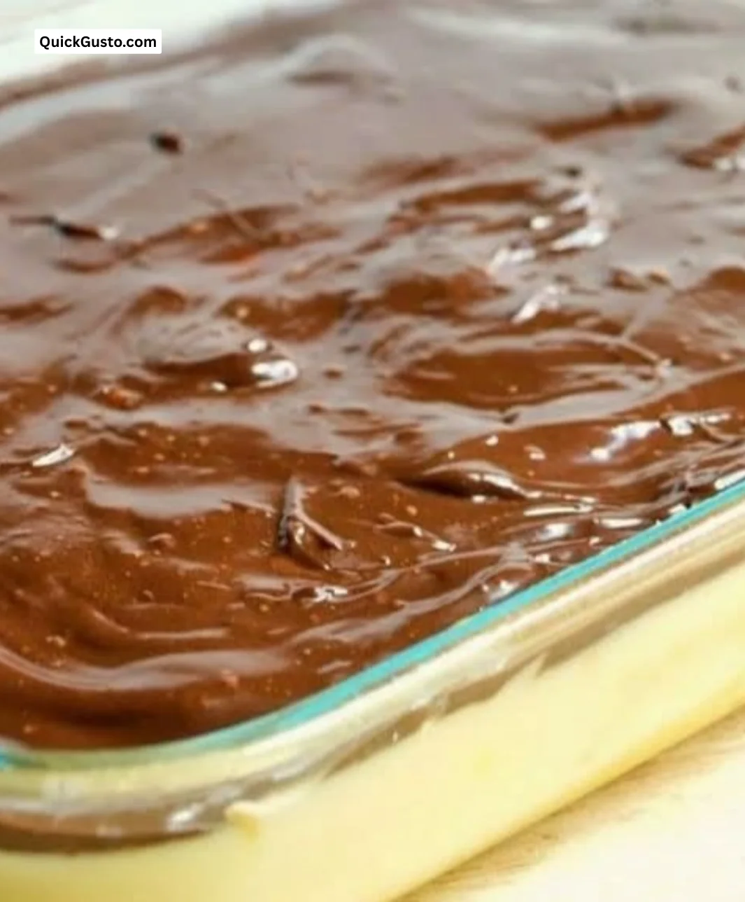 Homemade Boston Cream Pie Poke Cake topped with chocolate ganache and creamy filling.