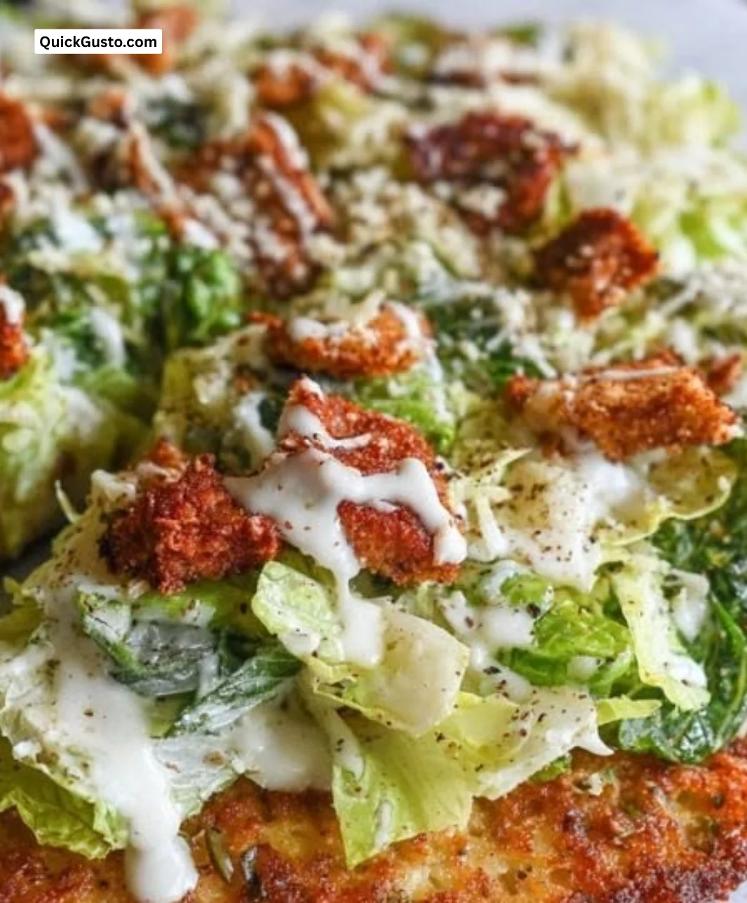 Chicken Caesar Salad Pizza topped with fresh greens and grilled chicken