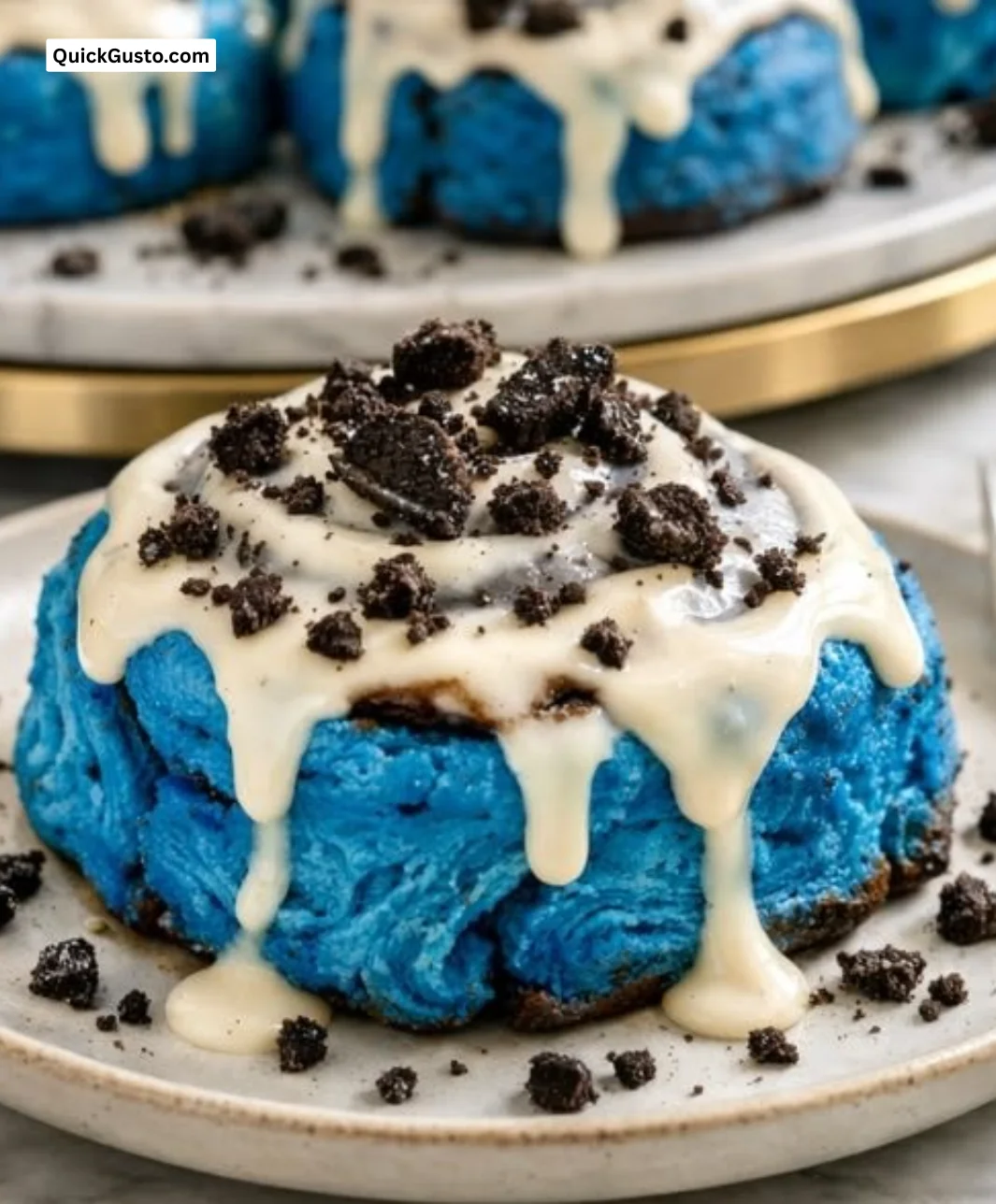 Cookie Monster cinnamon rolls topped with blue frosting and colorful sprinkles.