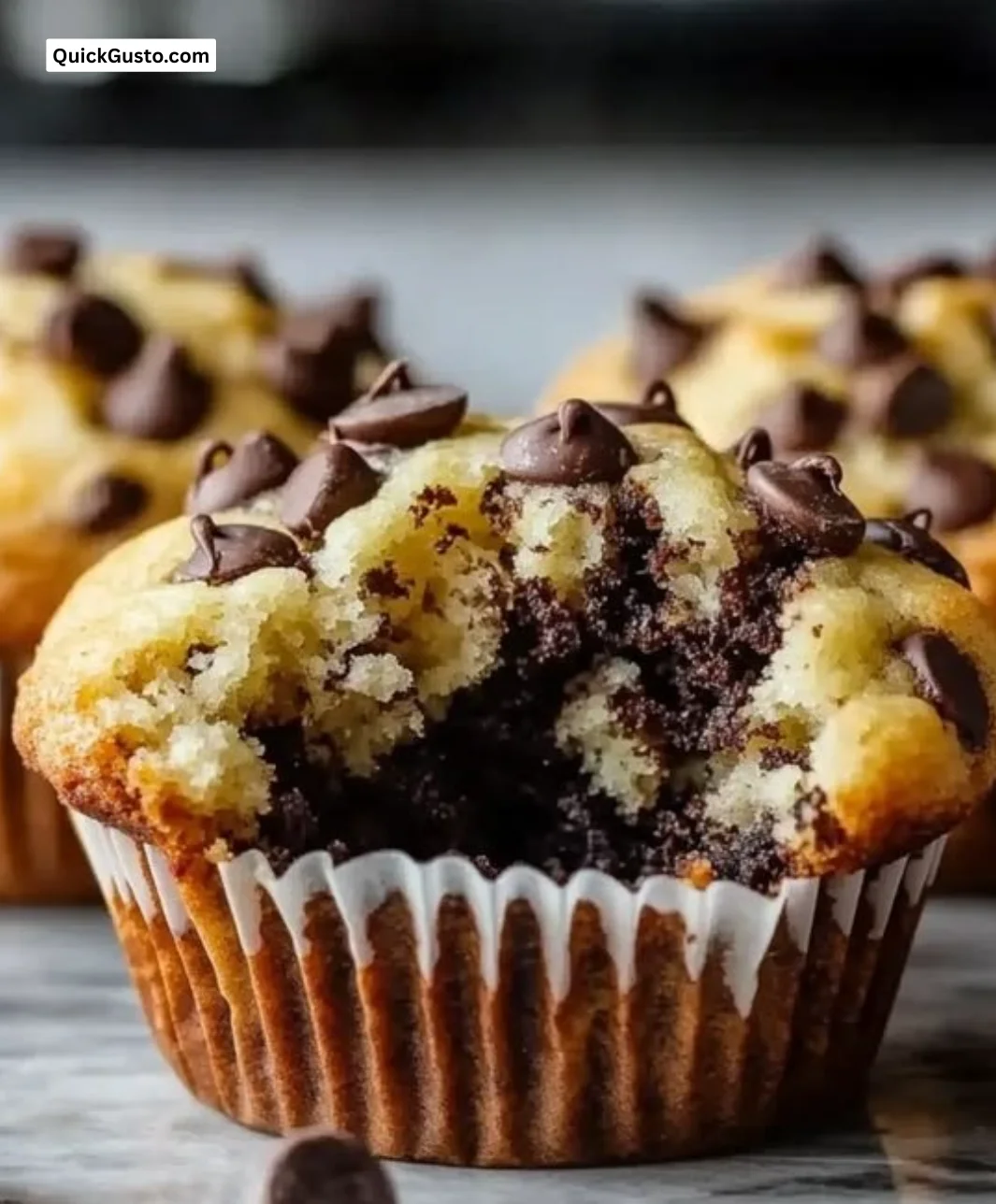 Delicious Greek Yogurt Chocolate Chip Muffins on a rustic wooden table