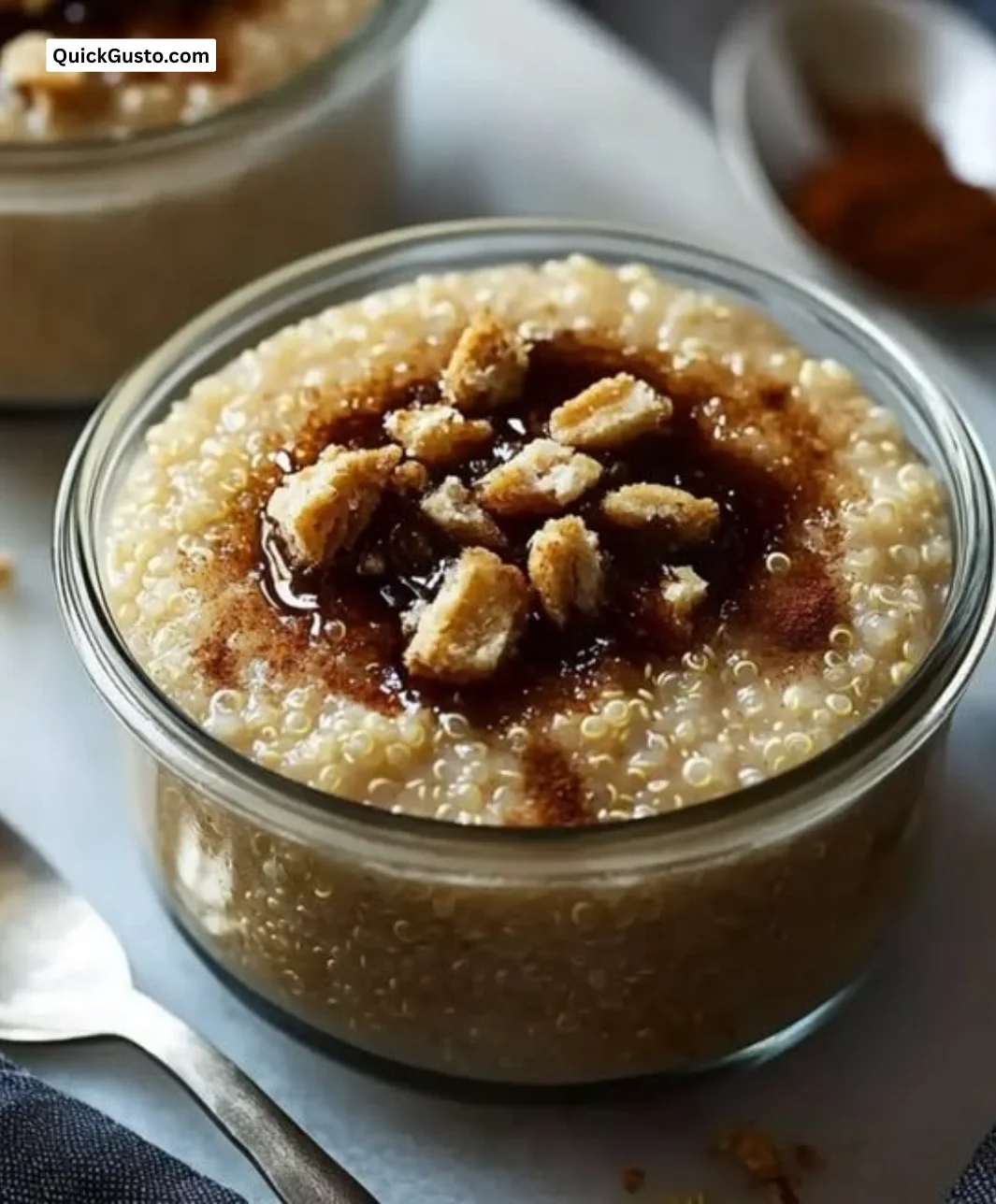 Delicious creamy quinoa pudding served in a bowl, topped with fruits.