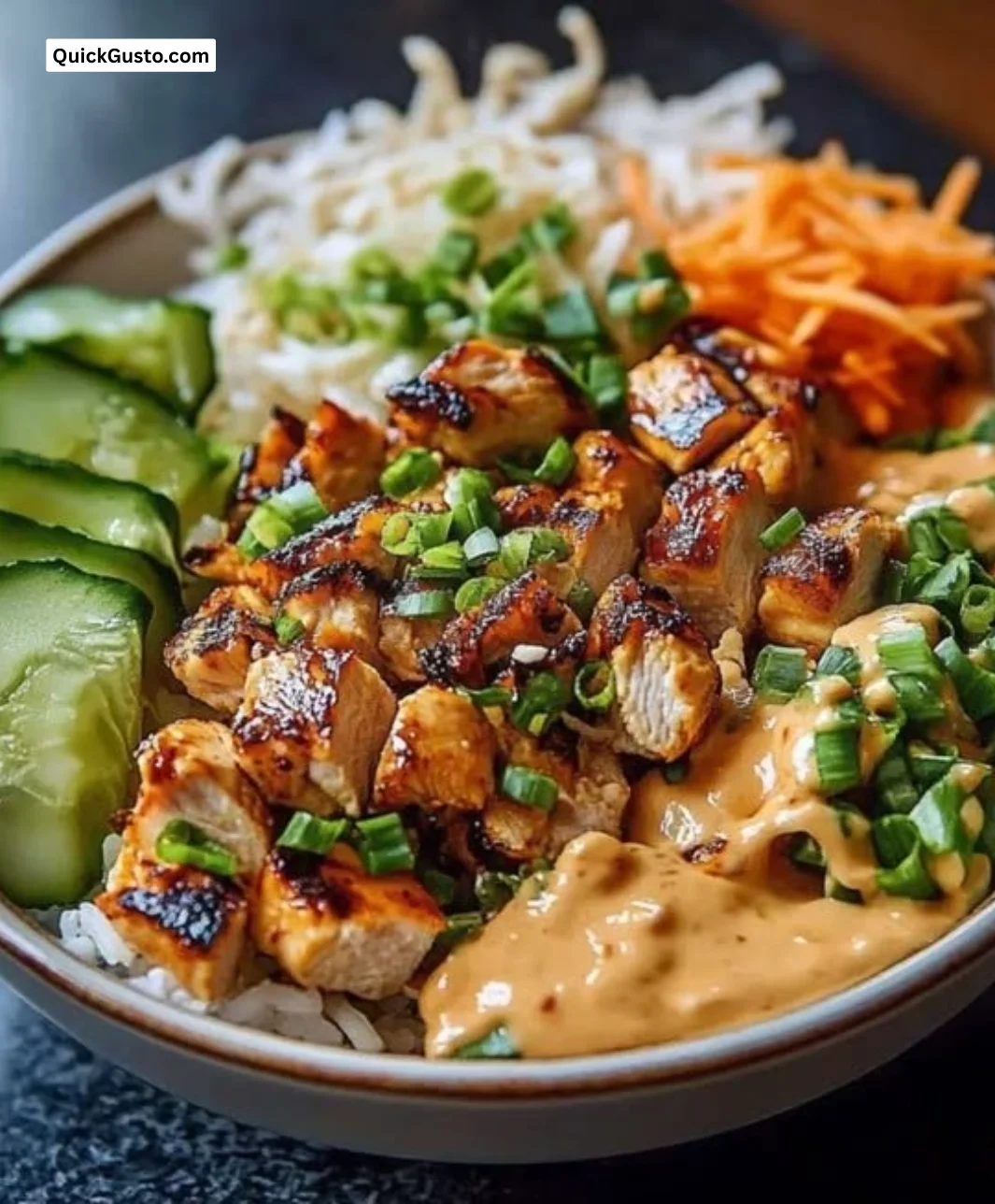 Creamy Thai Peanut Chicken Buddha Bowl topped with fresh vegetables and peanut sauce