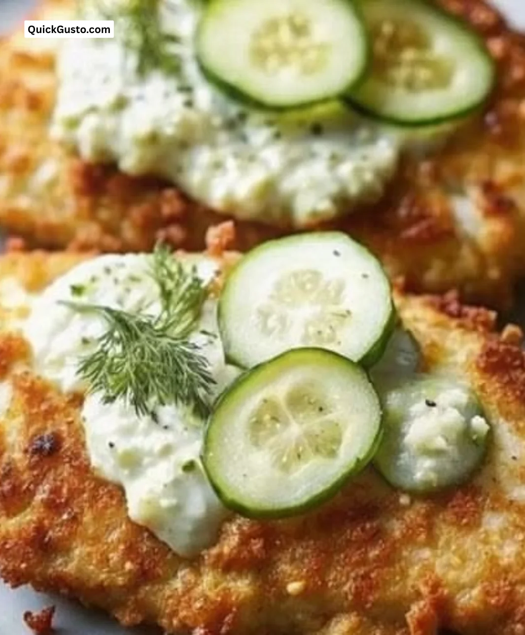 Delicious Crispy Dill Pickle Parmesan Chicken on a plate garnished with herbs.