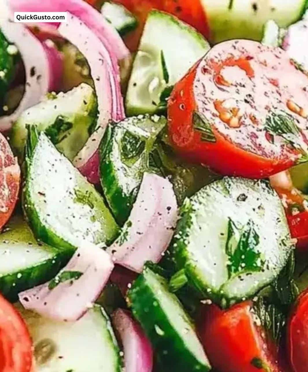 Fresh cucumber tomato salad served in a bowl with herbs and dressing