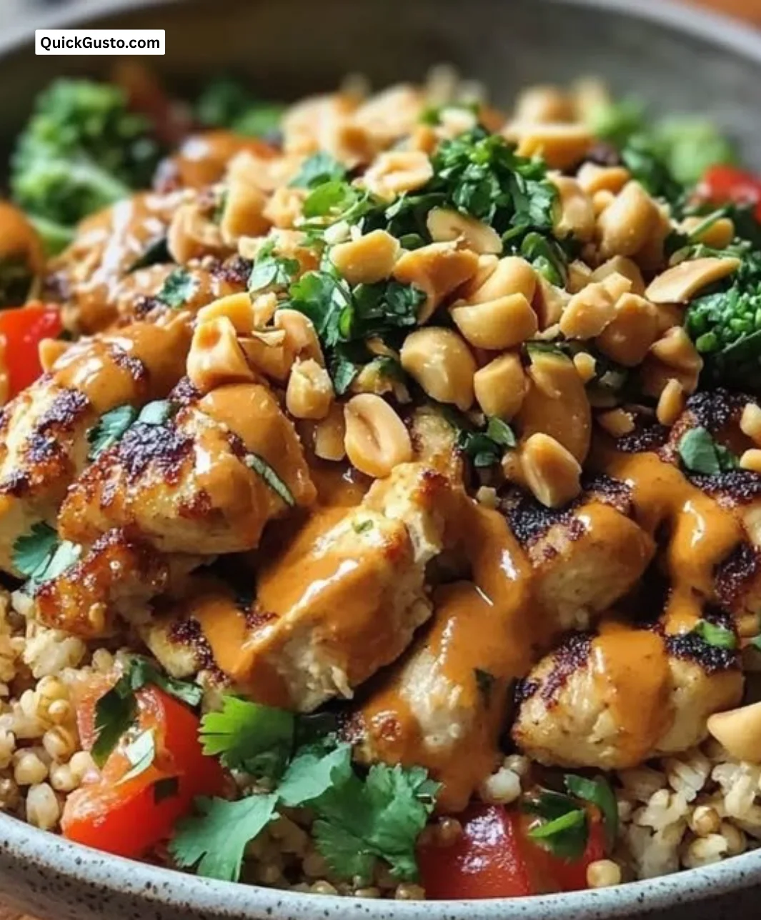 High-protein Thai Peanut Chicken Buddha Bowl with colorful veggies and peanut sauce