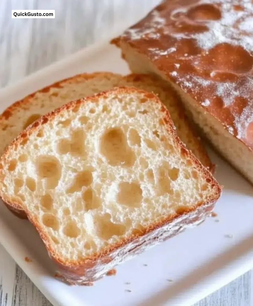 Sliced homemade English muffin bread ready for toasting with butter.