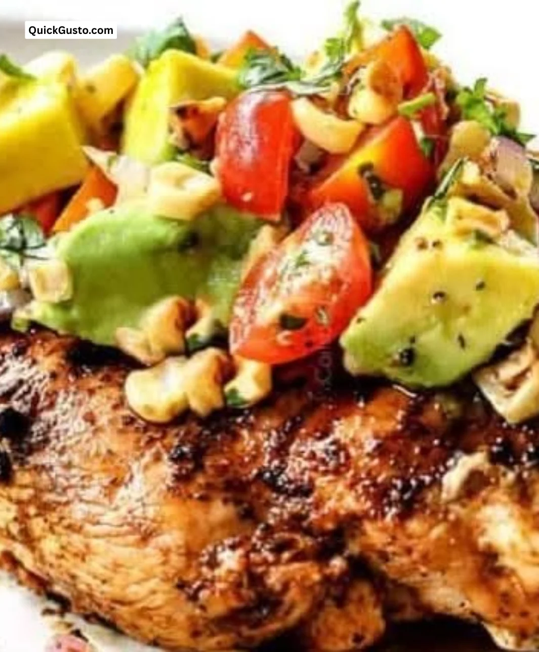 Delicious fiesta lime chicken with avocado garnishing, served on a plate.