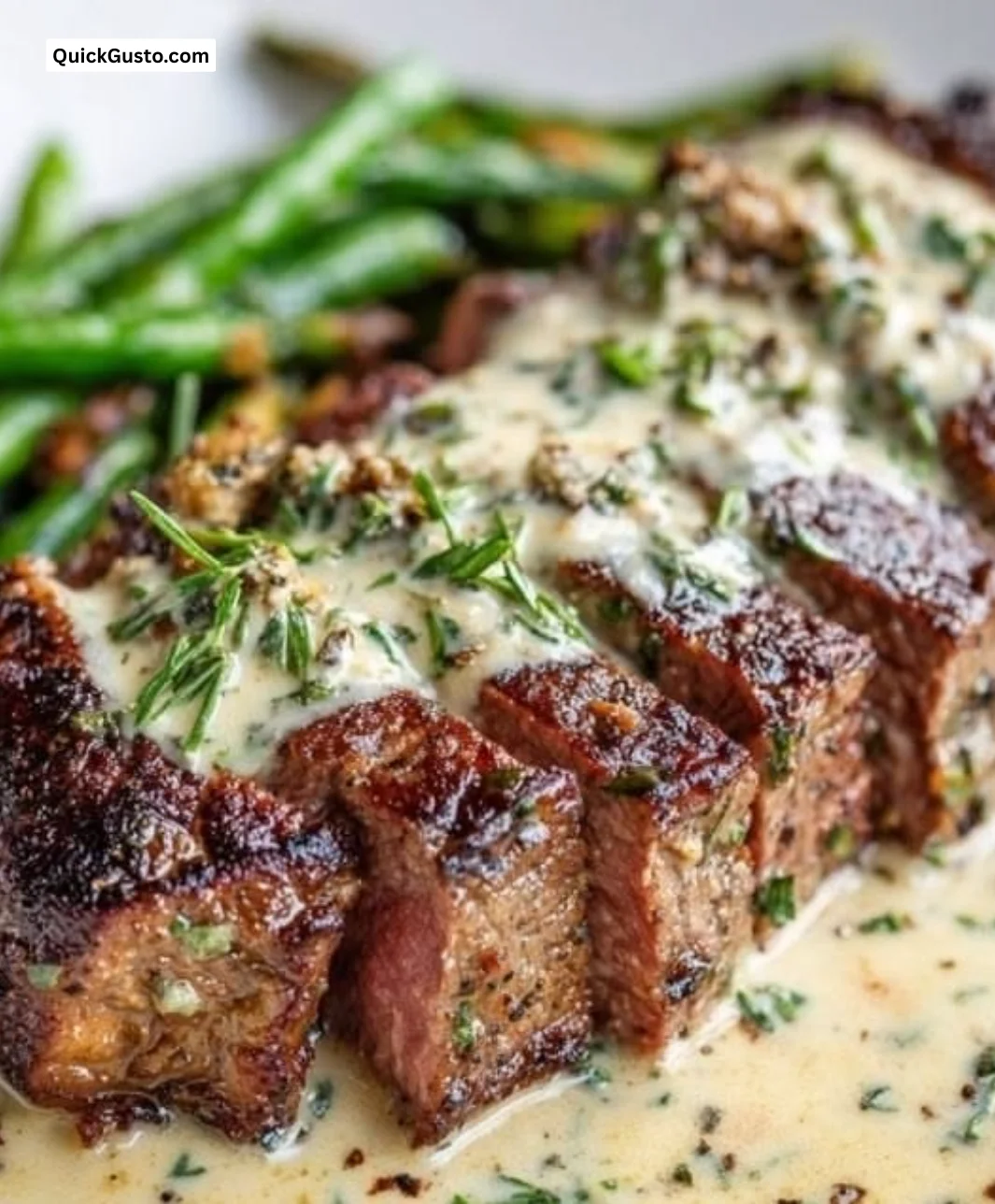 Delicious Garlic Butter Steak topped with Parmesan Cream Sauce on a plate