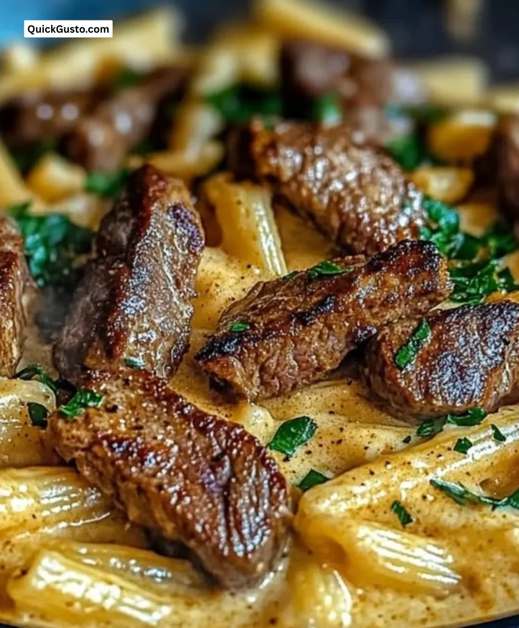 Delicious Cajun Butter Steak Pasta in a skillet, showcasing creamy sauce and tender steak.