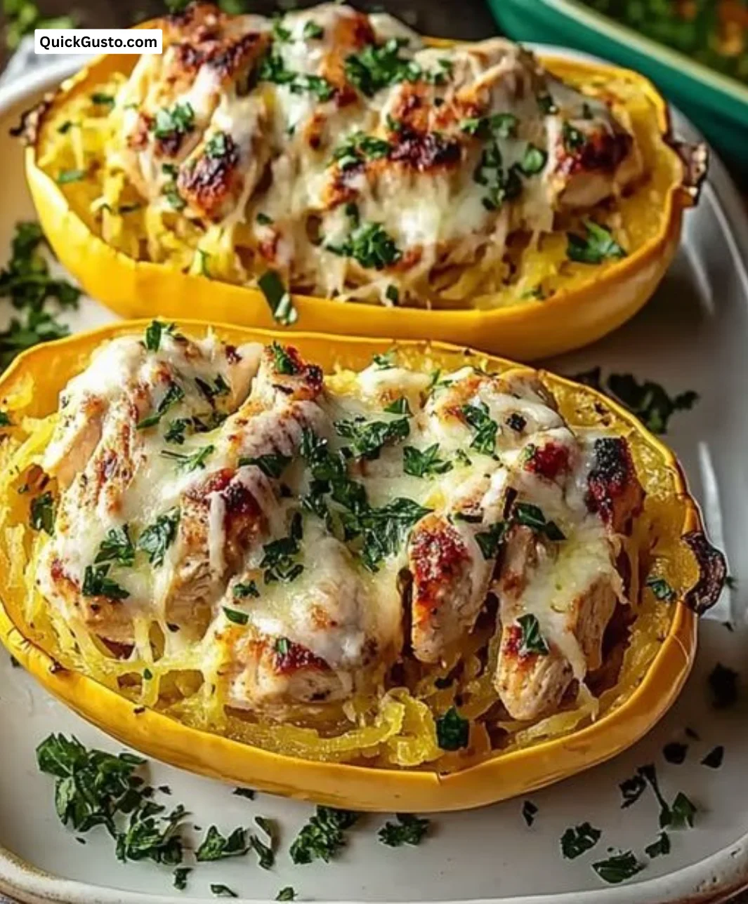 Delicious chicken spaghetti squash topped with creamy sauce and herbs