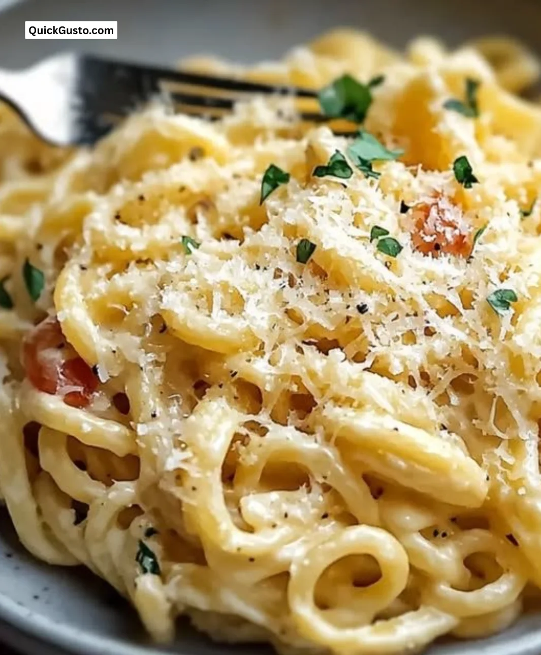 Creamy butter parmesan pasta served in a bowl, garnished with parsley and cheese.
