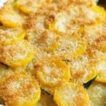 Creamy yellow squash casserole topped with cheese and breadcrumbs