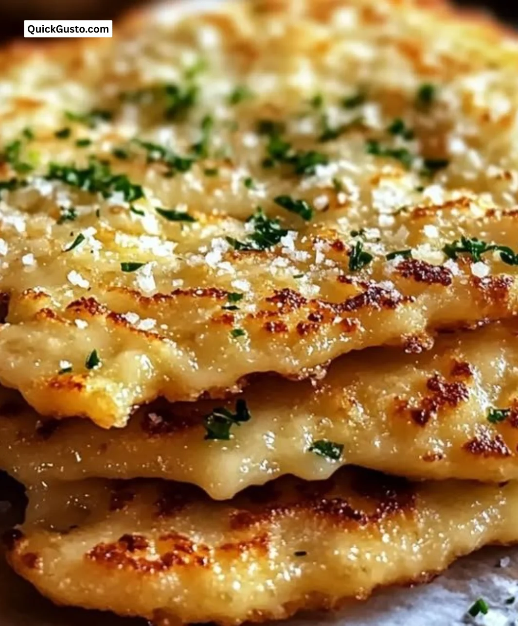 Easy keto garlic flatbread served on a wooden table with herbs