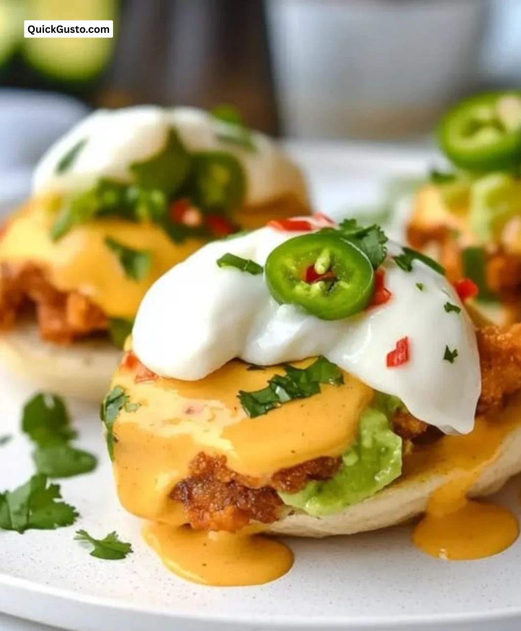Delicious plate of Mexican Eggs Benedict topped with spicy sauce and fresh ingredients