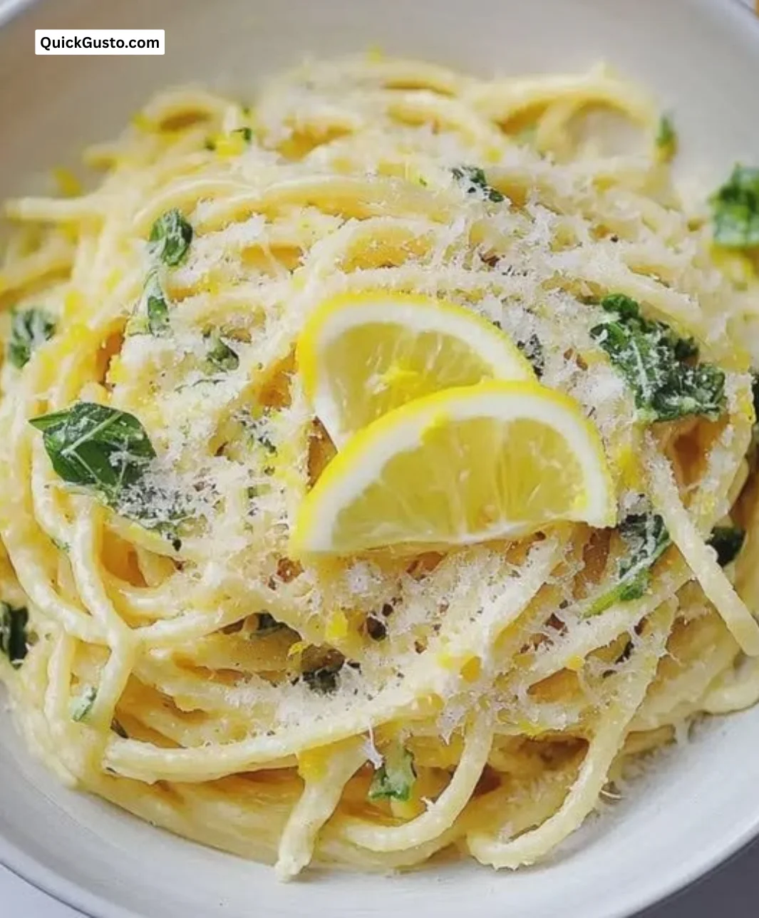 Delicious plate of lemon spaghetti garnished with fresh herbs and lemon zest