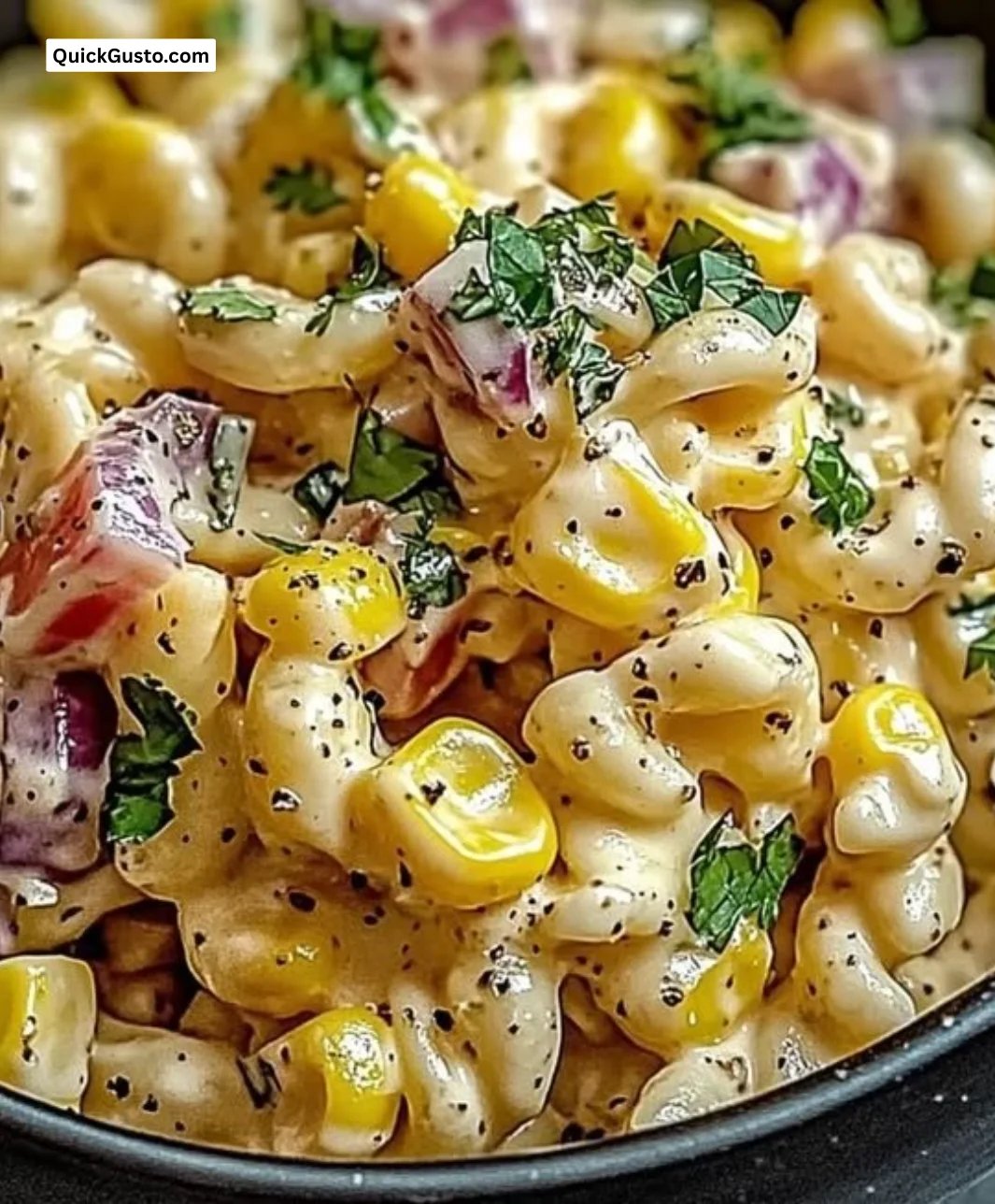 Colorful Mexican street corn pasta salad in a bowl with fresh vegetables.