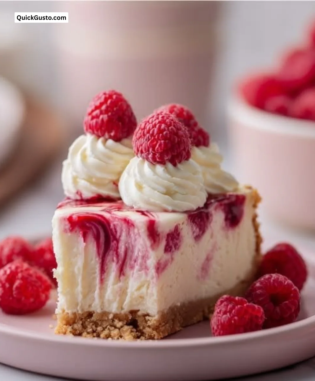 No Bake Raspberry Cheesecake served on a plate with fresh raspberries on top