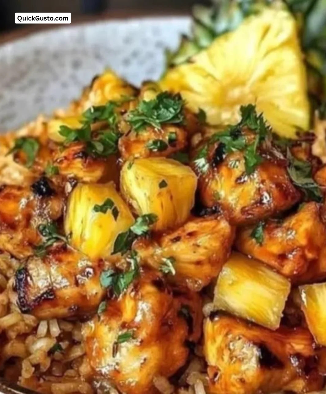 Delicious plate of pineapple chicken rice garnished with fresh herbs.