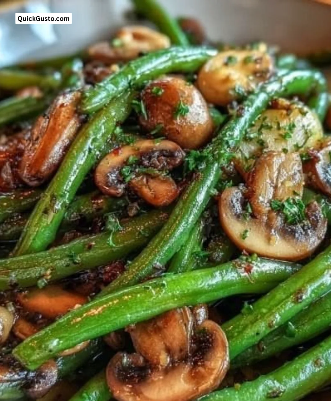 Savory garlic butter green beans and mushrooms dish served in a bowl.