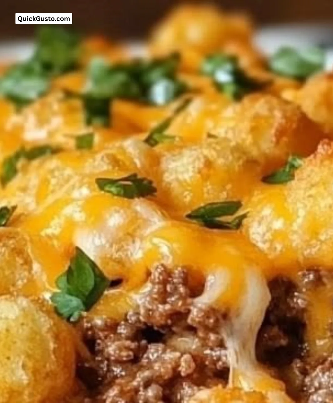 A hearty tater tot casserole dish topped with crispy tater tots and melted cheese