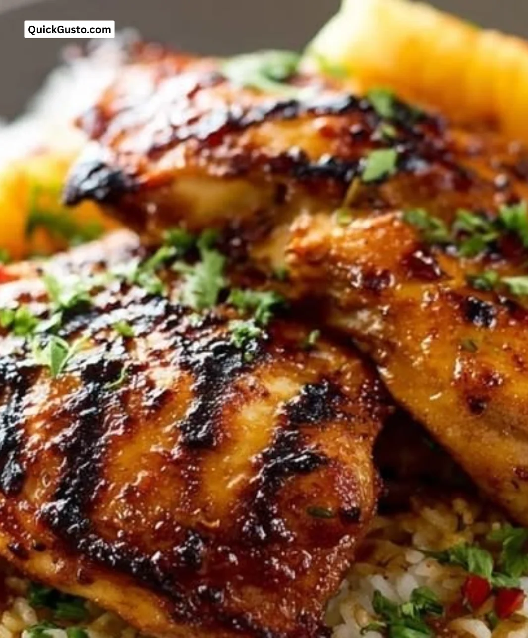 Plate of Hawaiian Chicken with coconut rice and tropical garnishes