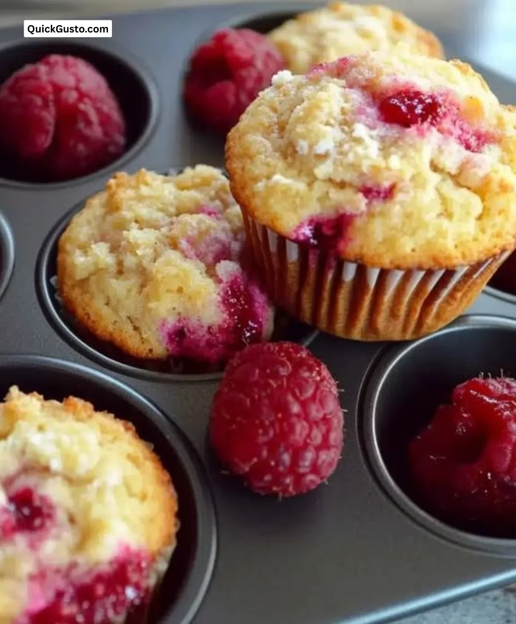 Sunlit raspberry muffins with Greek yogurt, showcasing their soft texture and vibrant color.