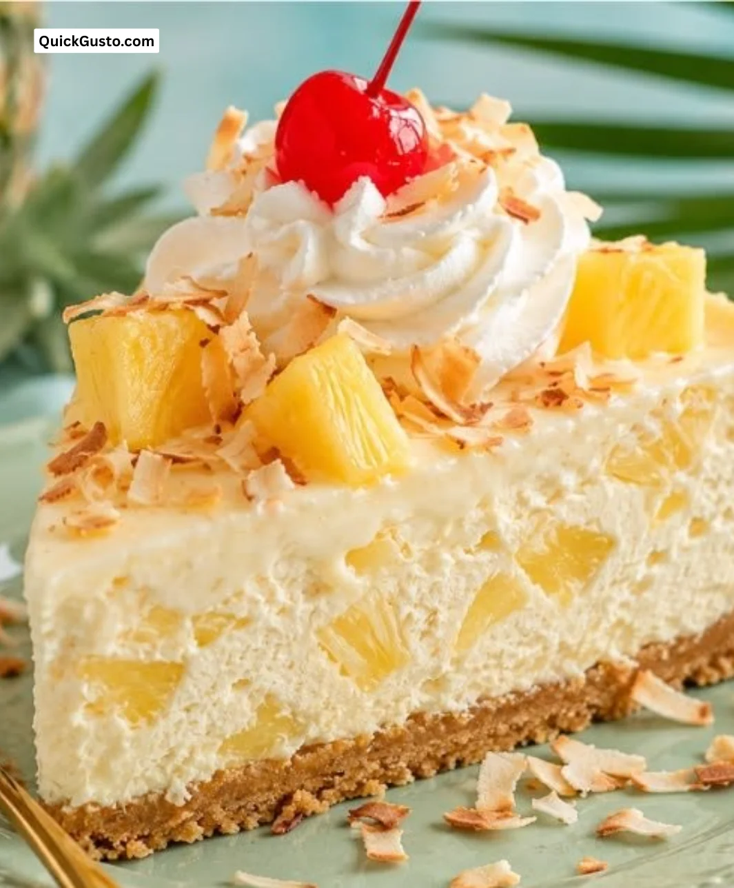 Slice of creamy Piña Colada Cheesecake topped with pineapple and coconut.