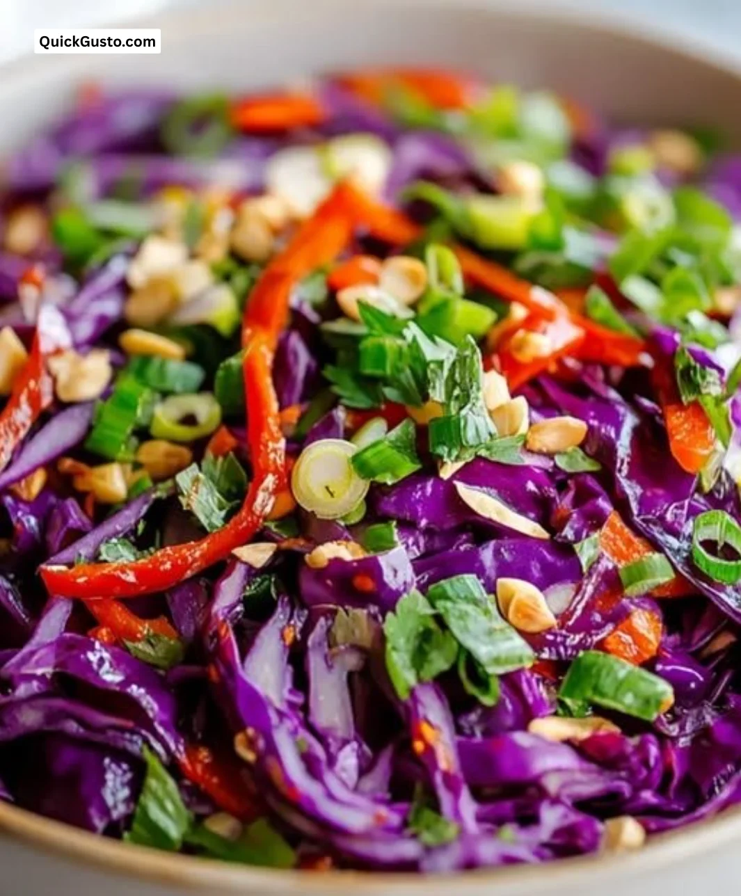 Vibrant purple cabbage salad with fresh vegetables and dressing