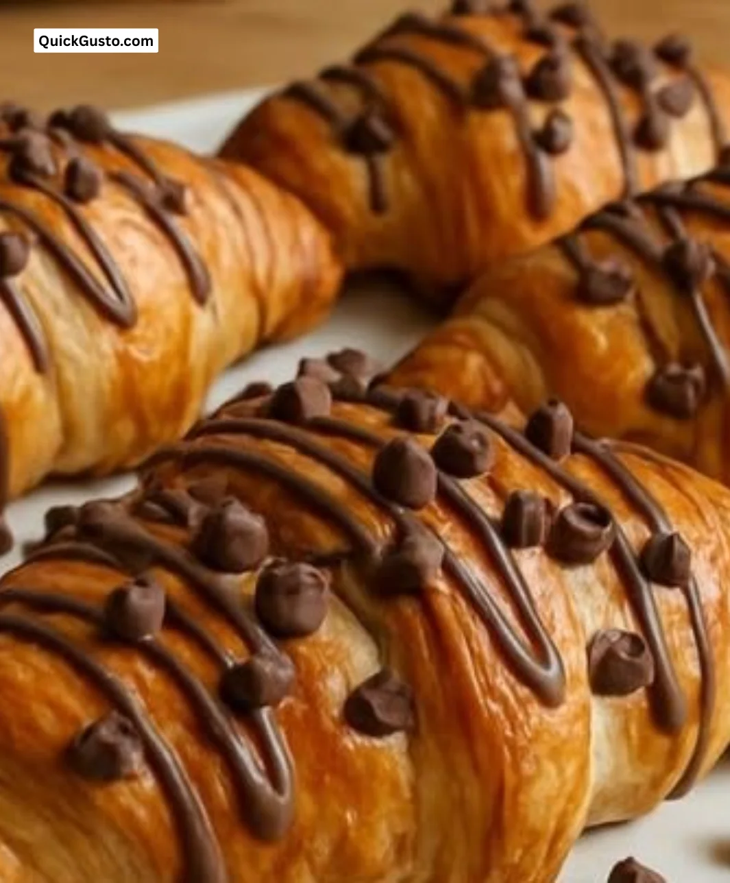 Air fryer croissants filled with Nutella and chocolate chips on a plate