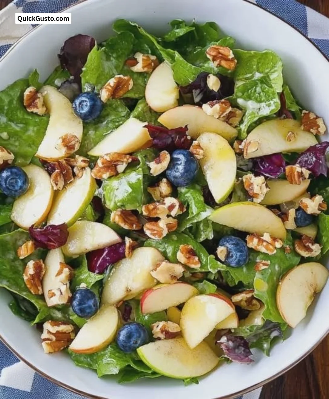 Delicious apple walnut salad garnished with fresh greens and herbs