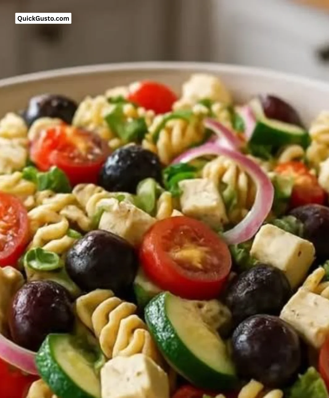 Colorful Mediterranean Pasta Salad with fresh vegetables and herbs.