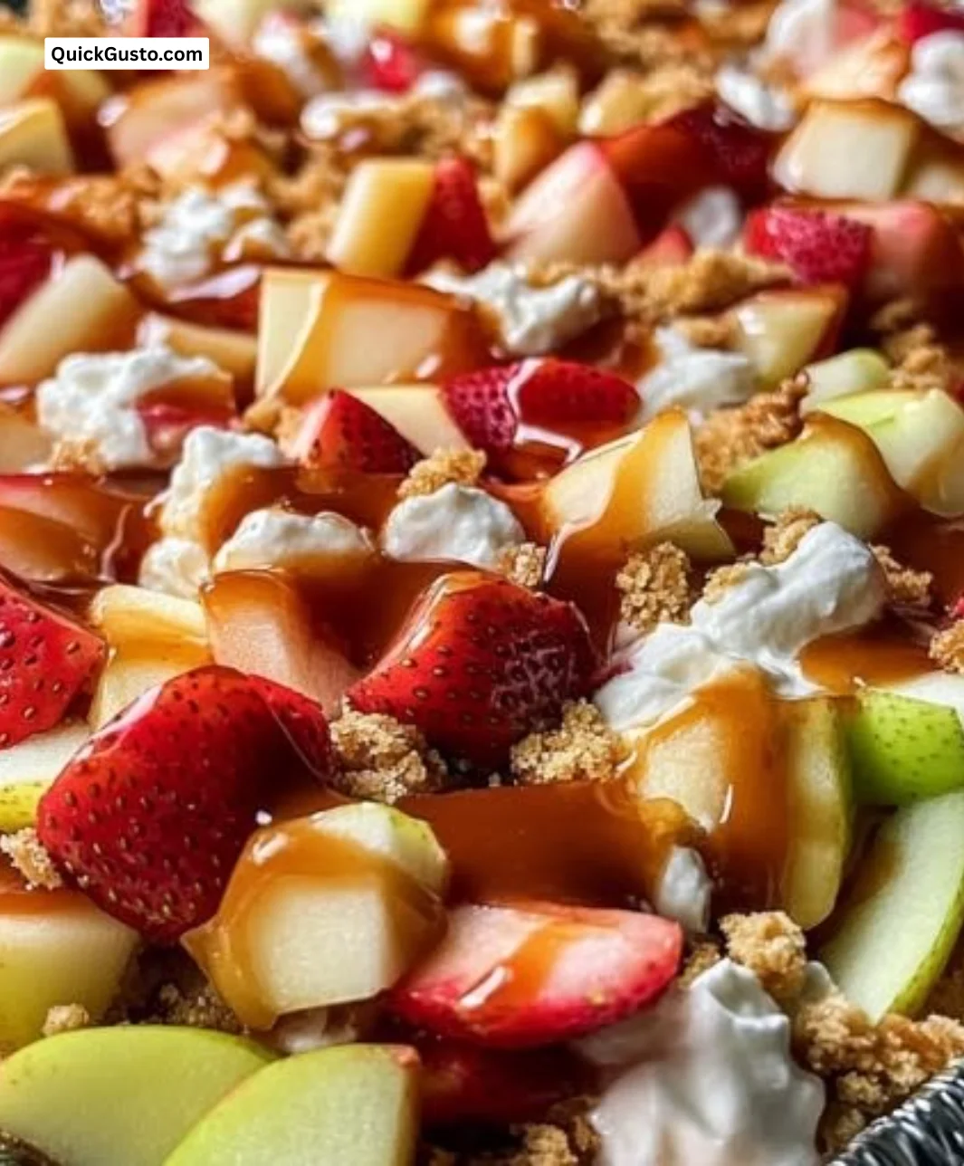 Delicious caramel apple strawberry cheesecake crunch salad served in a bowl