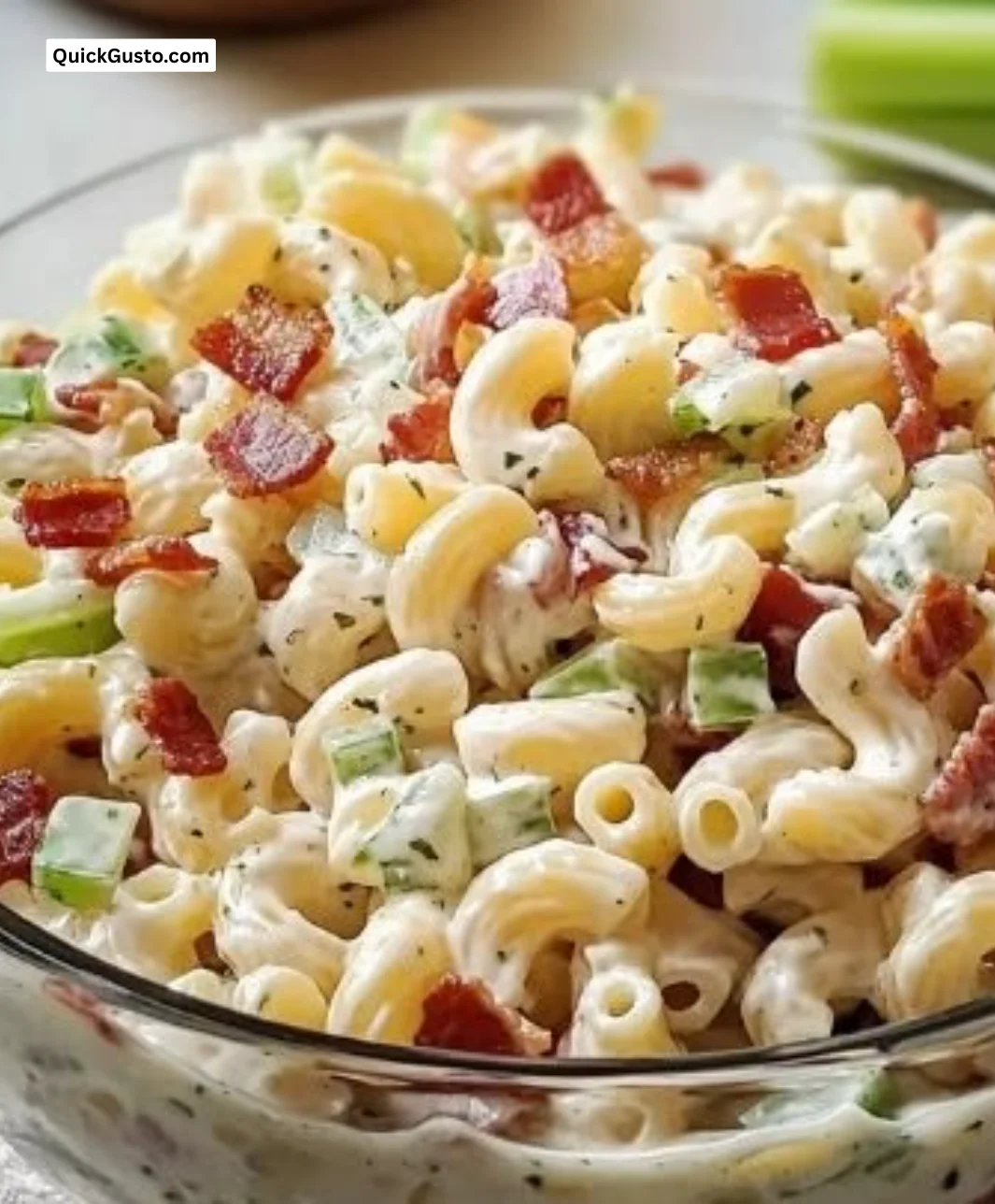 Bacon Macaroni Salad served in a bowl with crispy bacon and macaroni.