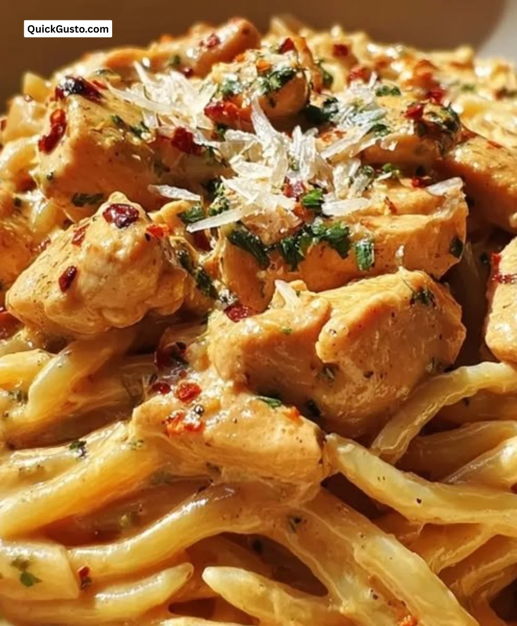 Creamy chipotle garlic chicken pasta served in a bowl, garnished with fresh herbs.
