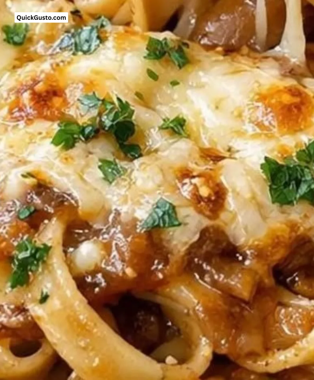 Creamy one pot French onion pasta served in a bowl with melted cheese and herbs.