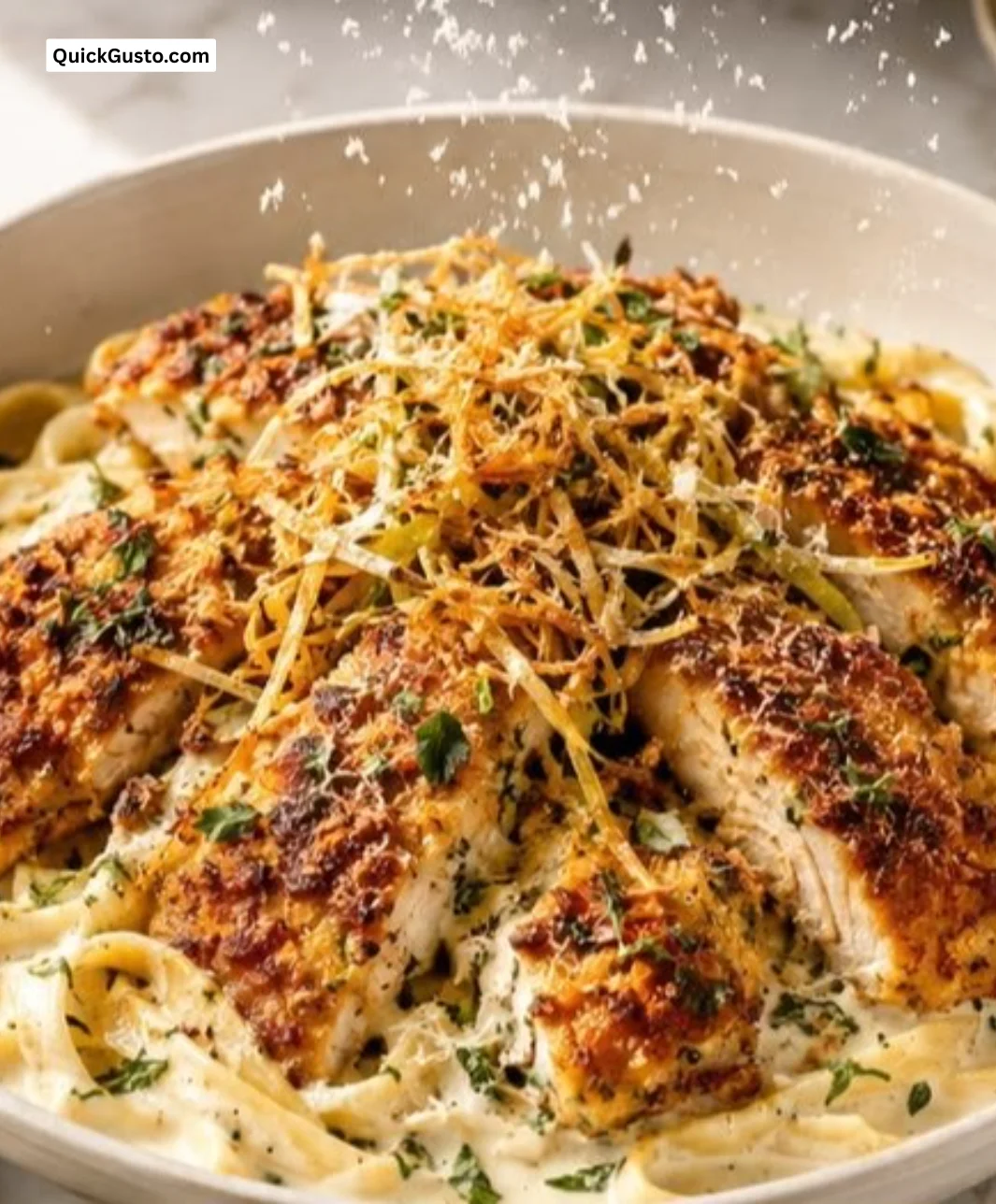 Creamy truffle feta alfredo served with herbed chicken and crispy parmesan leeks