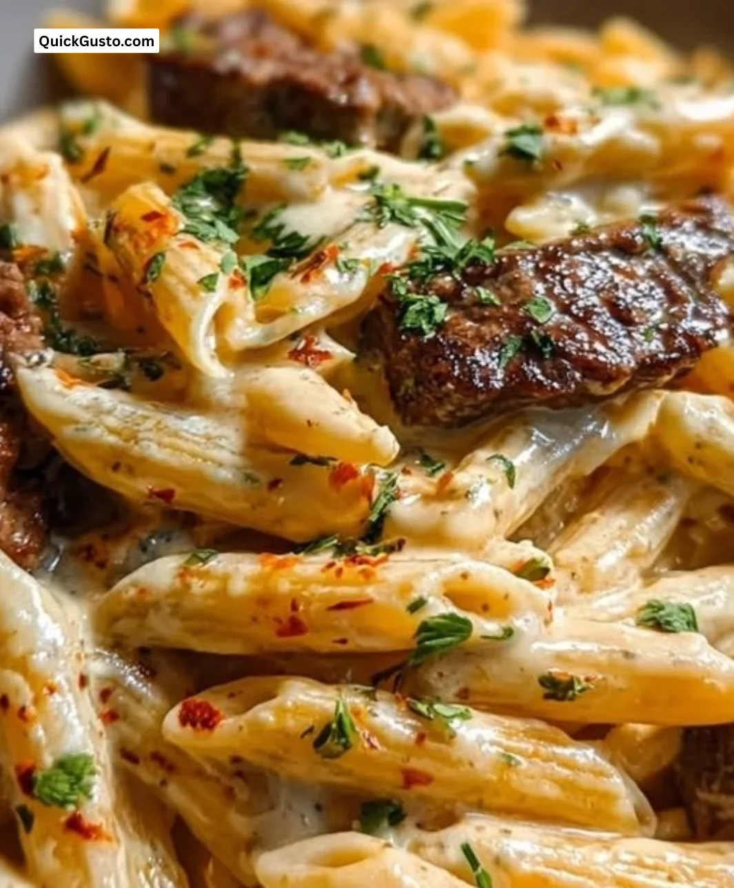Creamy White Cheddar Cajun Steak Penne served in a bowl