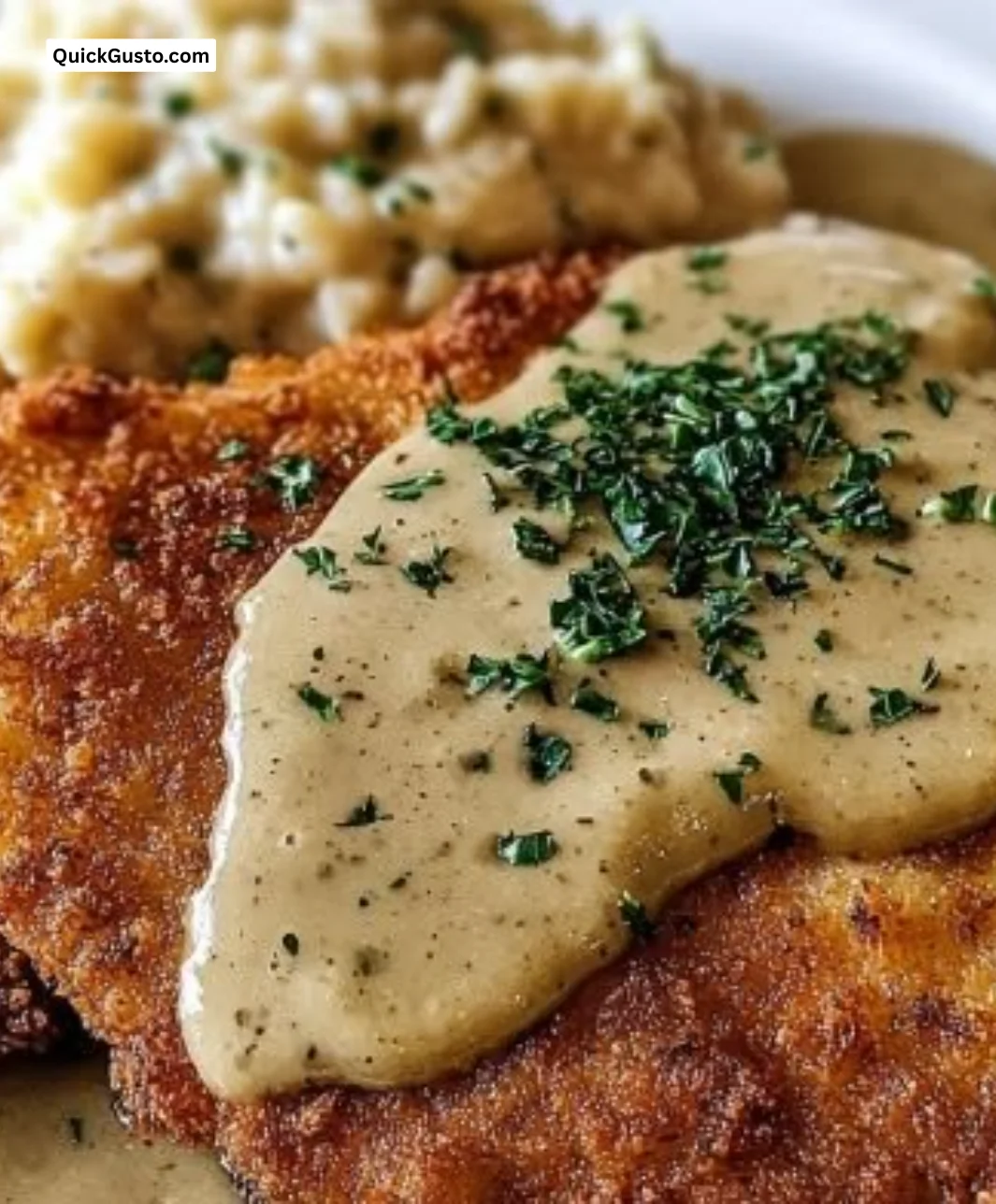 Crispy pork schnitzel served with creamy Dijon gravy for a delicious meal.