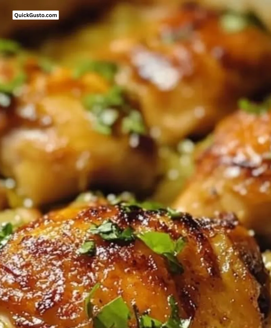 Crispy baked lemongrass chicken thighs garnished with herbs on a plate.